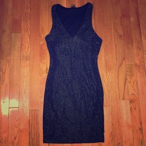 Sparkly black skin tight dress .